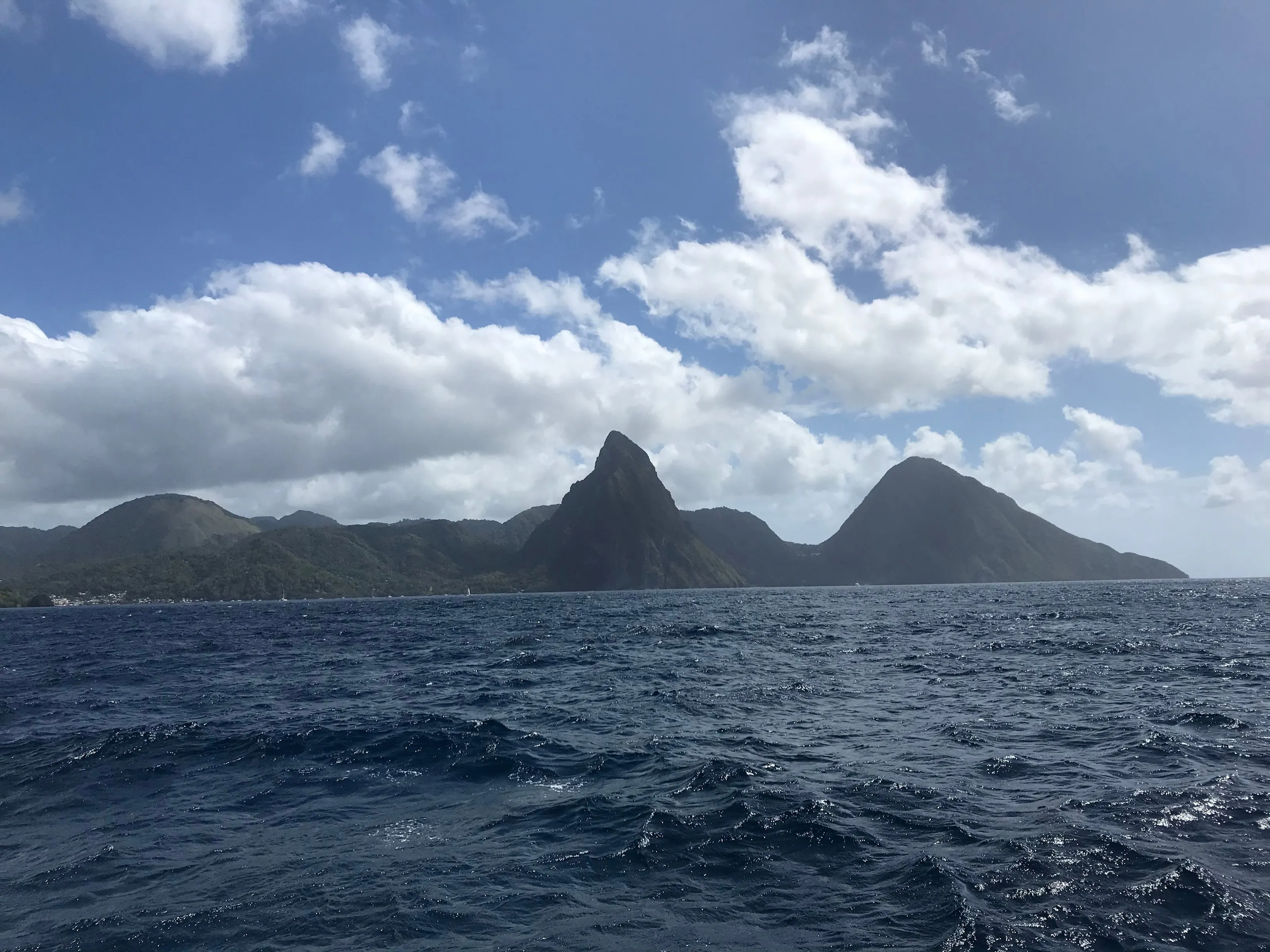 The two Pitons of Saint Lucia rising above the sea, seen from offshore.