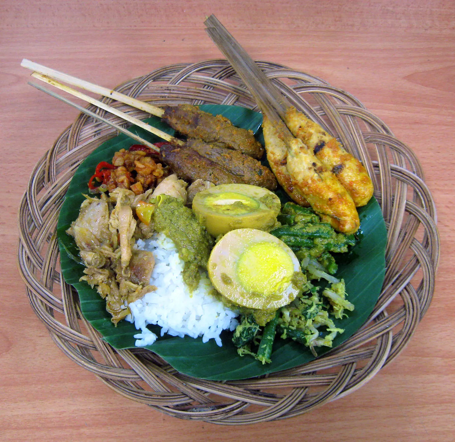 A plate of Balinese nasi campur with sate lilit.