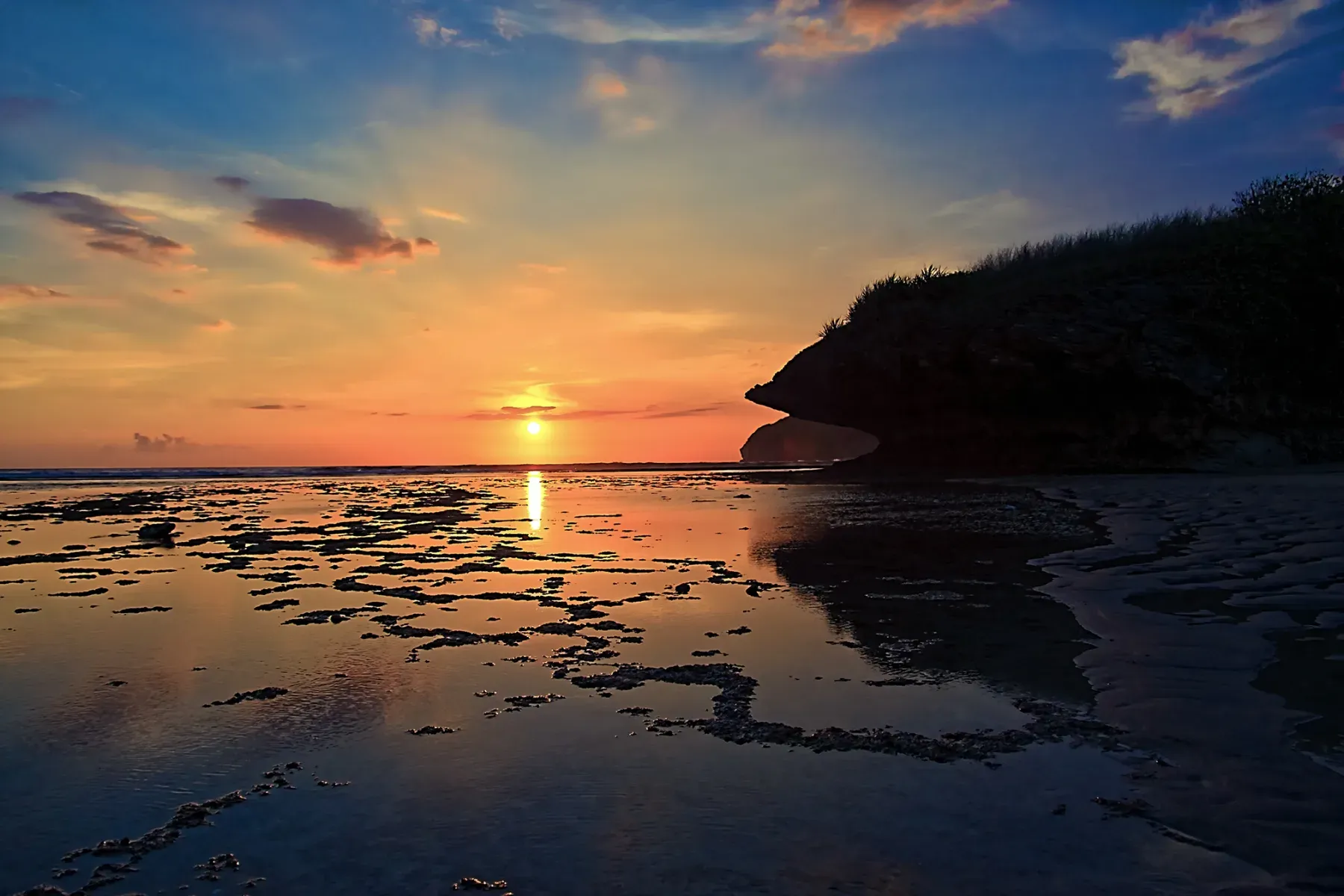 The sun sets over the sea at Sekongkang Beach in West Sumbawa